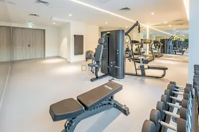 a gym with treadmills and a treadmill at City Views 1BR with Balcony Near Mall, Concept 7 Residences, Jumeirah Village Circle by Deluxe Holiday Homes in Dubai