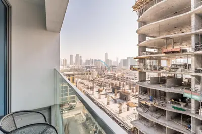 a view of a building under construction from a window at City Views 1BR with Balcony Near Mall, Concept 7 Residences, Jumeirah Village Circle by Deluxe Holiday Homes in Dubai