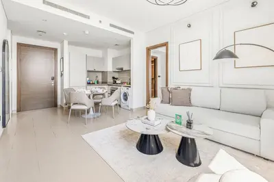a living room with a couch and a table at New 2BR with Pool and Gym in Green Sobha Community in Dubai