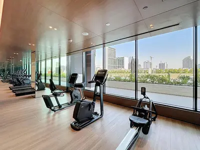 a gym with a row of exercise bikes in a building at Binghatti Onyx - Upgraded One Bedroom in JVC in Dubai