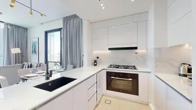 a white kitchen with a sink and a stove at Binghatti Onyx - Two Bedroom with Private Pool in Dubai