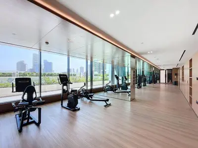 a gym with cardio equipment in a large building at Binghatti Onyx - Two Bedroom with Private Pool in Dubai