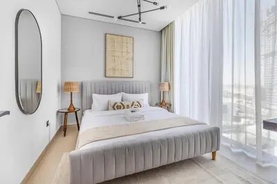 a bedroom with a large bed and a large window at New 2BR with BBQ Area, Pool in Sobha MBR City in Dubai