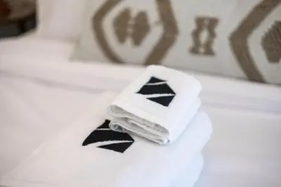 a pile of folded towels sitting on top of a sink at New 2BR with BBQ Area, Pool in Sobha MBR City in Dubai