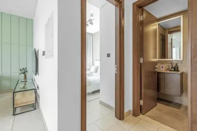 a hallway with a door leading to a bedroom at Stylish 1BR with Pool, BBQ Area, Gym in MBR City in Dubai