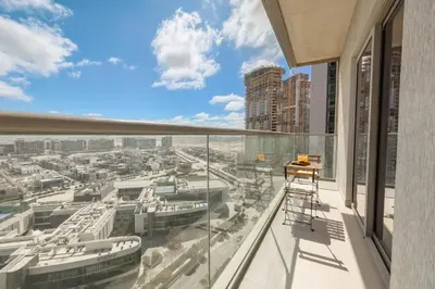 a balcony with a view of a city at Stylish 1BR with Pool, BBQ Area, Gym in MBR City in Dubai
