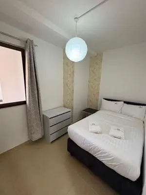 a bedroom with a large white bed and a window at Horizon JBR in Dubai
