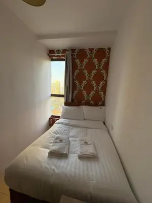 a bedroom with a bed with two towels on it at Horizon JBR in Dubai