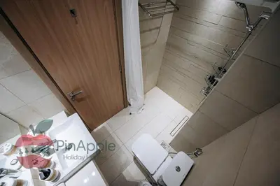 an overhead view of a bathroom with two toilets and a shower at Stylish studio in Azizi 42 in Dubai