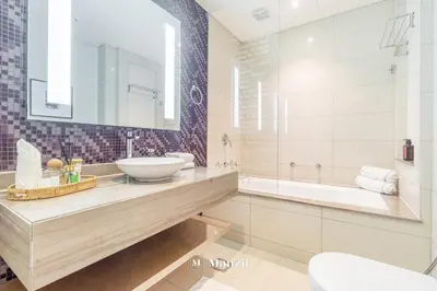 a bathroom with a sink and a tub at Luxury 1BR Apartment in Paramount Top-Floor Retreat in Dubai