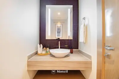 a bathroom with a sink and a mirror at Luxury 1BR Apartment in Paramount Top-Floor Retreat in Dubai