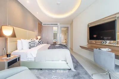 a bedroom with a large bed and a tv at Luxury 1BR Apartment in Paramount Top-Floor Retreat in Dubai