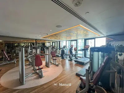 a gym with treadmills and ellipticals in a building at Luxury 1BR Apartment in Paramount Top-Floor Retreat in Dubai