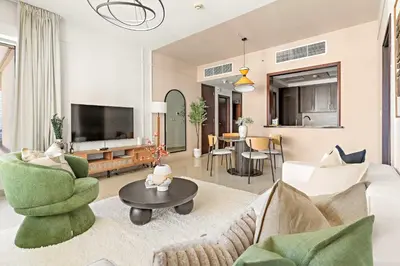 a living room with a couch and chairs and a tv at Silkhaus Elite 1BDR at 29 Boulevard Downtown in Dubai