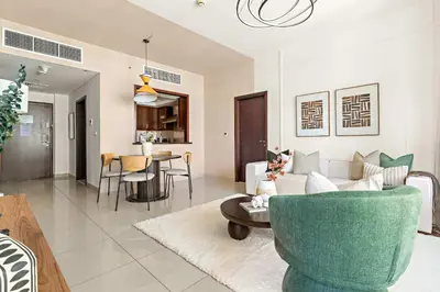 a living room with a couch and a table at Silkhaus Elite 1BDR at 29 Boulevard Downtown in Dubai