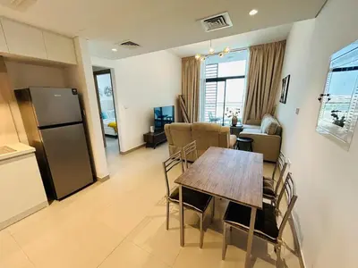 a kitchen and dining room with a table and a refrigerator at Beautiful view, fully-equipped apartment in Dubai