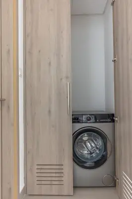 a washer and dryer sitting inside of a closet at Beautiful view, fully-equipped apartment in Dubai