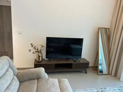 a living room with a flat screen tv on a table at Beautiful view, fully-equipped apartment in Dubai