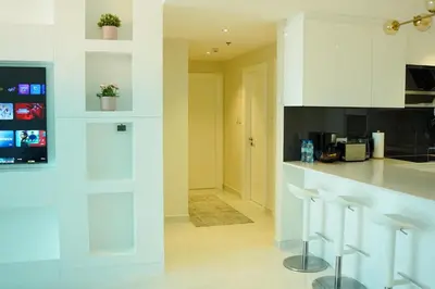 a kitchen with white cabinets and a counter top at Zapbed House-Cozy 2 BR Apartment In The Greens Golf View in Dubai