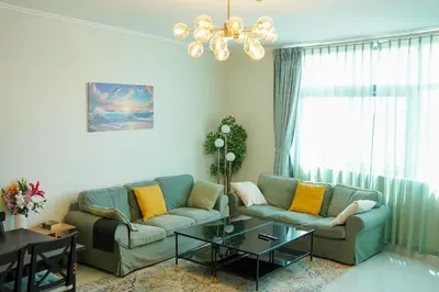 a living room with a couch and a table at Zapbed House-Cozy 2 BR Apartment In The Greens Golf View in Dubai