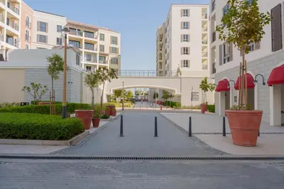 an empty street in a city with buildings at High-End Luxury 1BR in Port De La Mer near J1 Beachfront, Dubai in Dubai