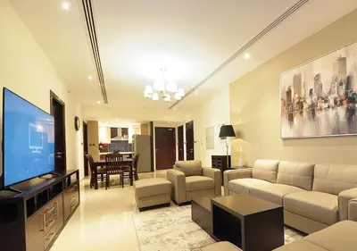 a living room with a couch and a television at Luxury 3BR Apartment By Elite Residence Downtown in Dubai