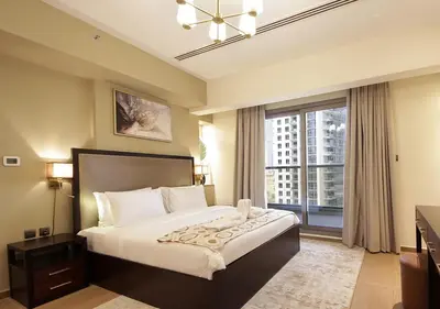a bedroom with a large bed and a large window at Luxury 3BR Apartment By Elite Residence Downtown in Dubai