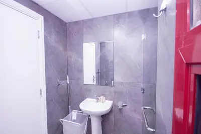 a bathroom with a sink and a shower at Cozy Studio for Daily Rental Warsan in Dubai