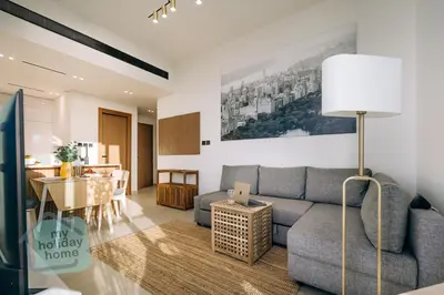 a living room with a couch and a table at Fully furnished with stunning panoramic view in Dubai