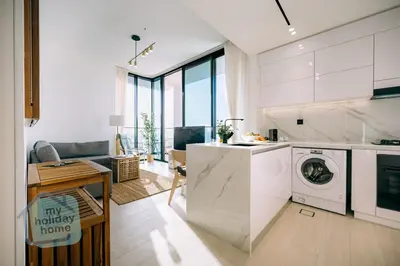 a kitchen with a washer and dryer in a room at Fully furnished with stunning panoramic view in Dubai
