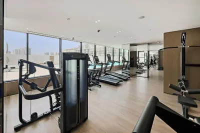 a gym with a bunch of treadmills in a building at Fully furnished with stunning panoramic view in Dubai