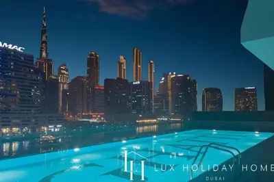 a view of a city skyline at night at LUX The Modern Binghatti Canal Suite 2 in Dubai