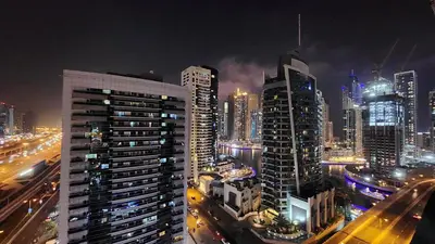a view of a city at night with buildings at Marina Nest - Spacious one bed apt with a view in Marina, walking distance from JBR, metro & tram! in Dubai