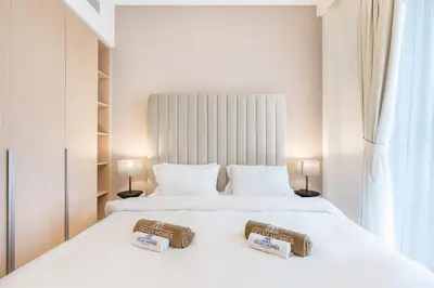 a bedroom with two beds with towels on them at Chic Bright Home in Creek Beach with Lagoon Access in Dubai