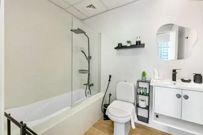 a bathroom with a toilet and a shower and a sink at Waves- Cozy 1BR Lakefront Stay in JLT in Dubai