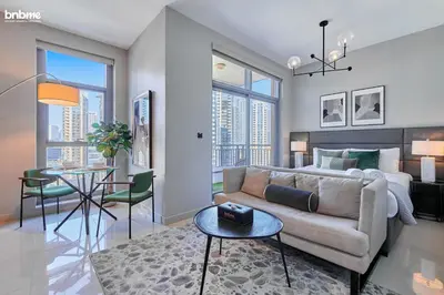 a living room with a couch and a table at bnbmehomes - Claren Tower in Dubai