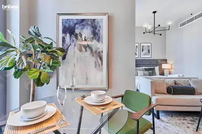 a living room with a glass table and a couch at bnbmehomes - Claren Tower in Dubai