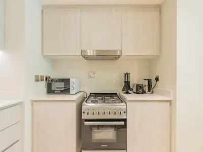 a kitchen with a stove and a microwave at Beach Escape 1BR-Vida Residences Creek Beach in Dubai