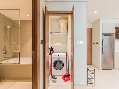 a kitchen with a washer and dryer in a room at Beach Escape 1BR-Vida Residences Creek Beach in Dubai