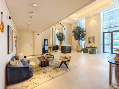 a large living room with couches and tables at Beach Escape 1BR-Vida Residences Creek Beach in Dubai