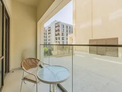 a balcony with a glass table and a chair at Beach Escape 1BR-Vida Residences Creek Beach in Dubai
