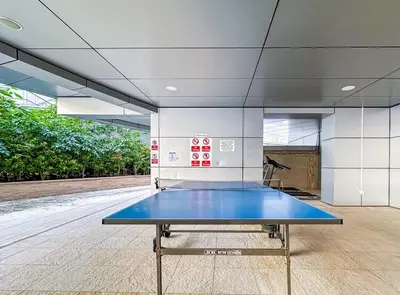 a ping pong table in the middle of a room at Female - Girls Joyful Journeys - girls only bedspace in Dubai