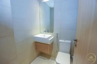 a white bathroom with a sink and a toilet at Luxury 2-BHK Apartment Located in Azizi riviera 47 Riv 47-419 in Dubai