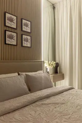 a bedroom with a bed and some pictures on the wall at Cozy 1 bdr apartment with pool and beach access in Dubai