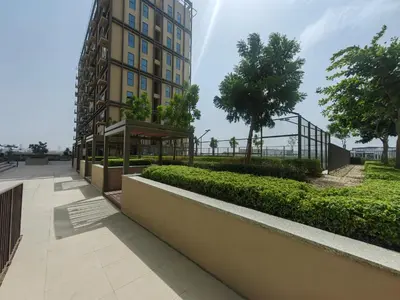 a building with a walkway in front of a building at Cozy 1 bdr apartment with pool and beach access in Dubai