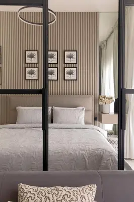 a bedroom with a bed with a black and white bedspread at Cozy 1 bdr apartment with pool and beach access in Dubai