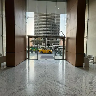 a hallway with a yellow car in a building at Luxurious Belvilla 1BR JVC with Pool, Gym & BBQ Access in Dubai