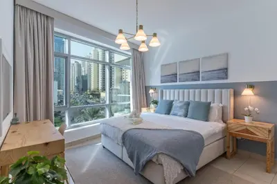 a bedroom with a bed and a large window at Elegant 1BR At Sanibel Tower park Island Tower Dubai Marina by al sarya holiday homes in Dubai