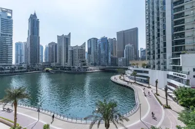 a river in the middle of a city with buildings at Elegant 1BR At Sanibel Tower park Island Tower Dubai Marina by al sarya holiday homes in Dubai