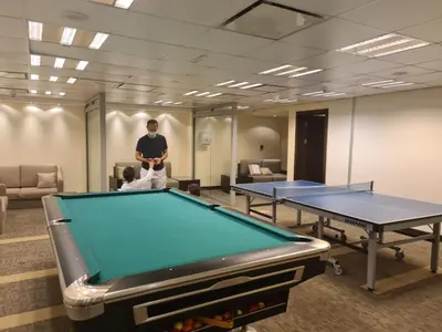 a man standing in a room with two ping pong tables at Elegant 1BR At Sanibel Tower park Island Tower Dubai Marina by al sarya holiday homes in Dubai